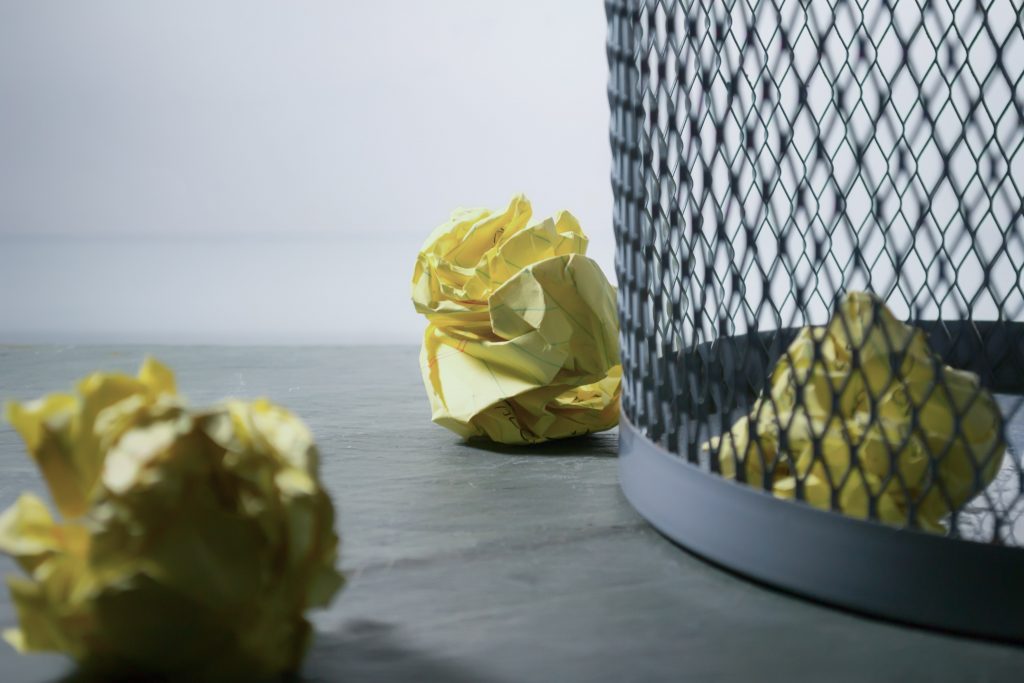 crumpled paper in a waste basket